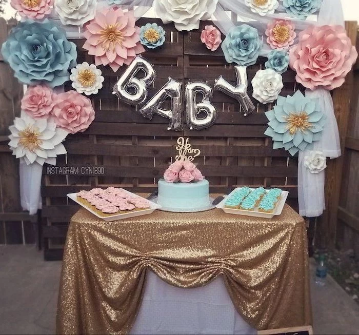 pink and blue flowers, dessert table, cake in the middle, cupcake trays, unique gender reveal ideas