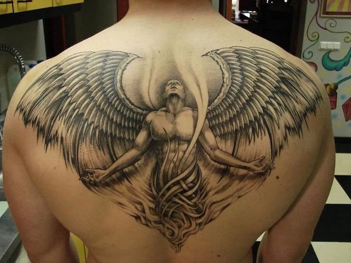 back tattoo, man looking up, with angel wings, wings chest tattoo, black and white tiled floor