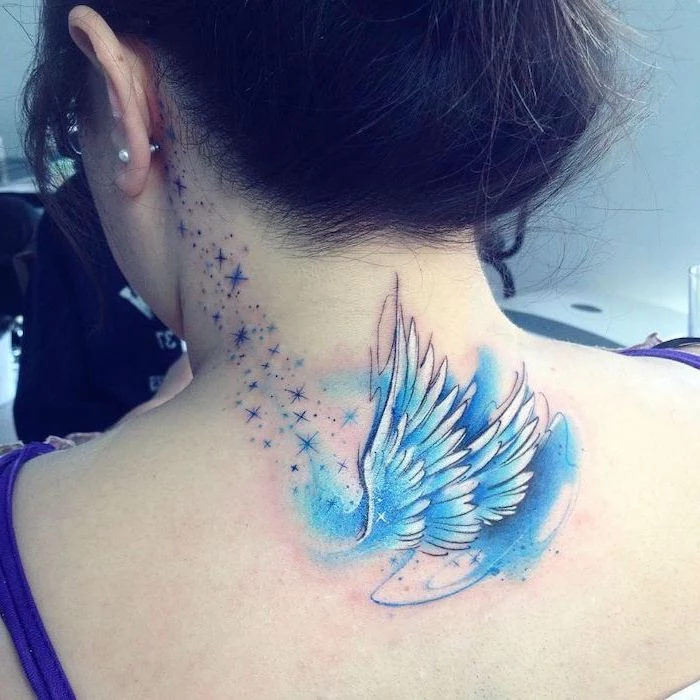 woman with brown hair, guardian angel tattoo, watercolor tattoo, blue color, back tattoo, stars tattoo behind the ear