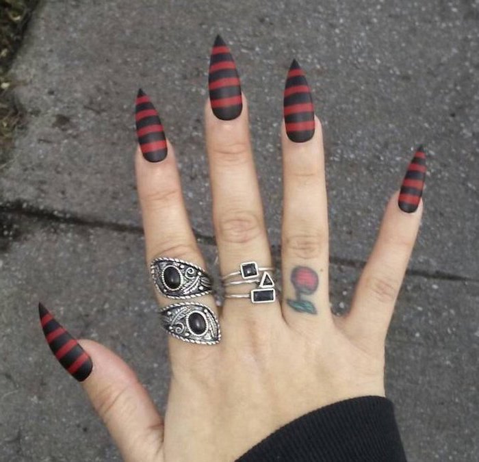 black and red, matte nail polish, candy corn nails, striped nails, long stiletto nails, silver rings, cherry finger tattoo