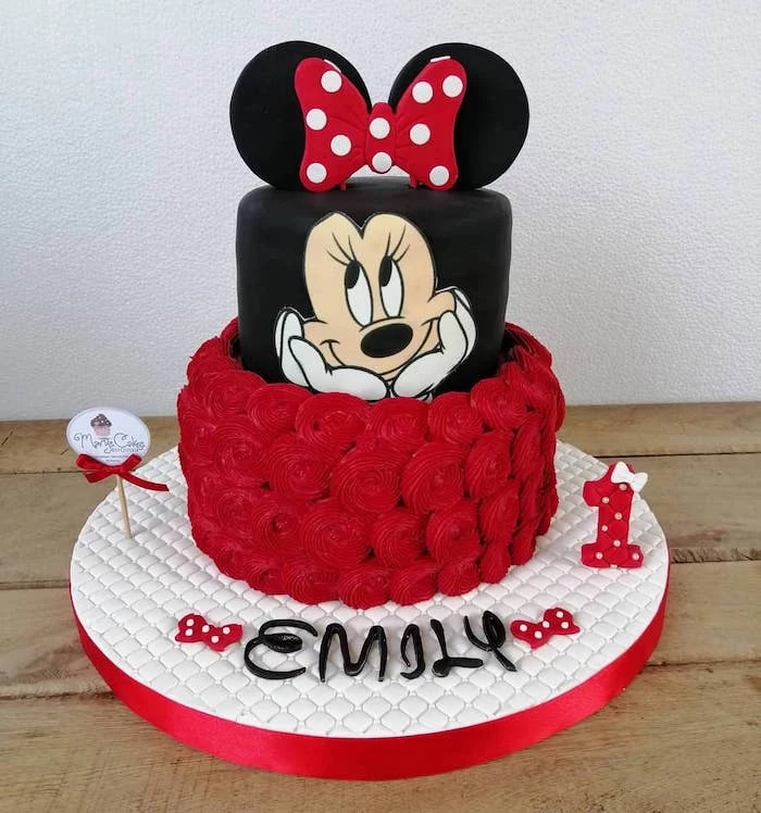 black fondant, red frosting, two tier, minnie mouse cake, white cake tray, wooden table