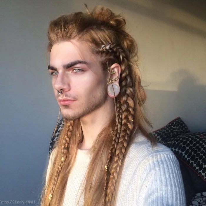 braided hairstyles, man with long, blonde hair, wearing a white sweater, nose ring