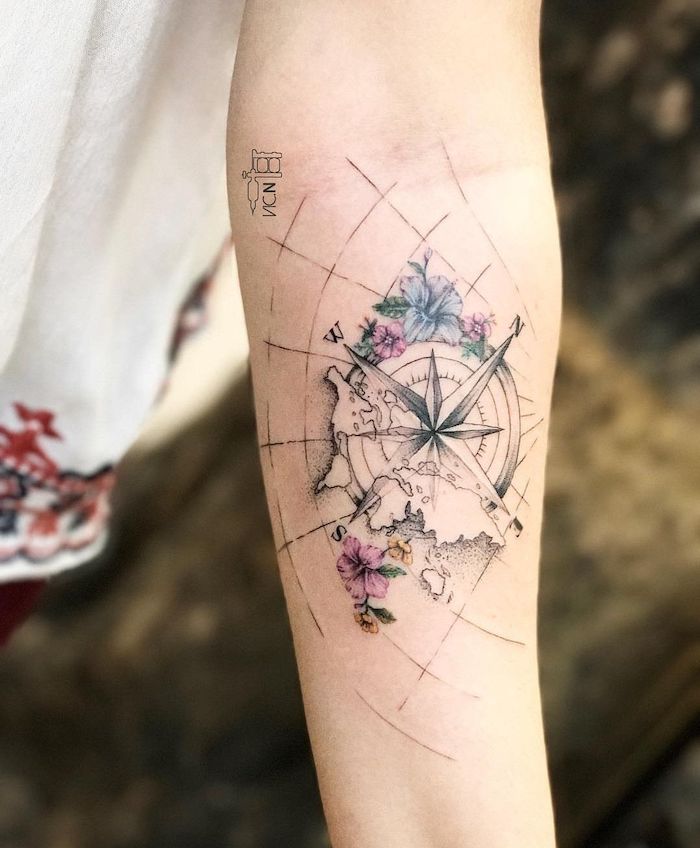 map of the world, blue and pink flowers, compass tattoo meaning, forearm tattoo, blurred background
