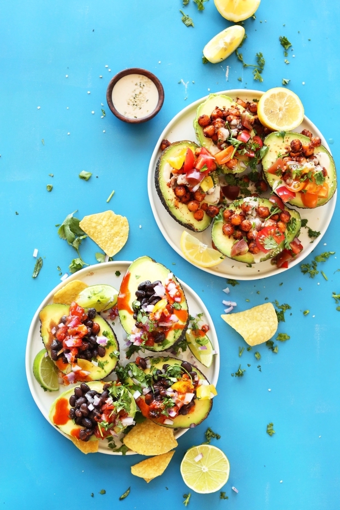 blue background, breakfast potluck ideas, halved avocados, filled with, chopped vegetables