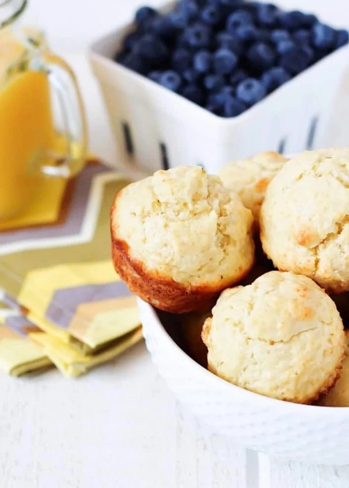 blueberries in a bowl, good breakfast ideas, white bowl, full of muffins, white wooden table