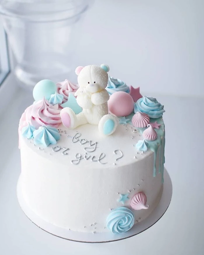 small cake, with white frosting, white teddy bear, cake topper, gender reveal games, blue and pink decorations