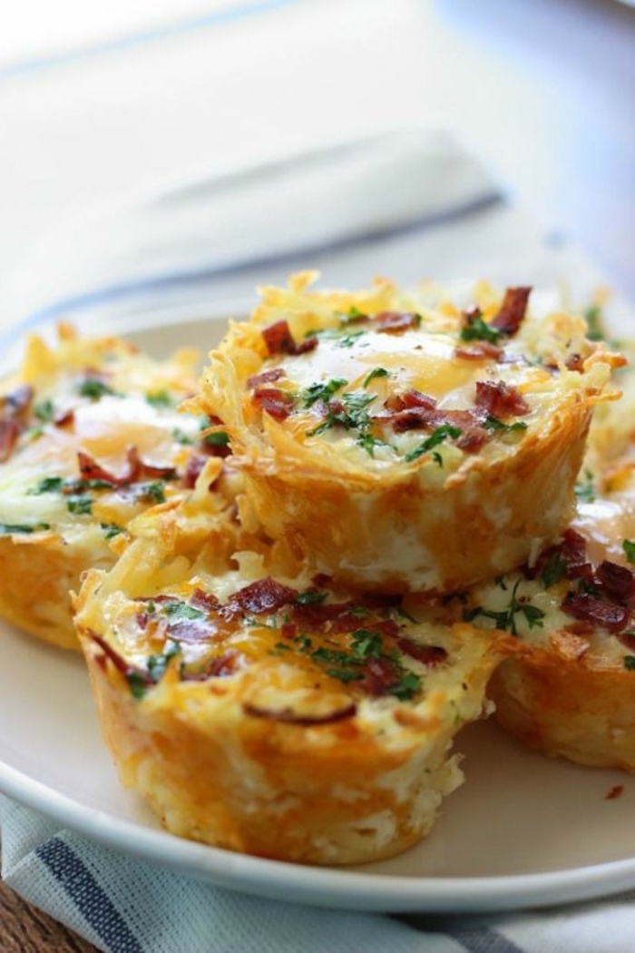 egg muffins, breakfast food ideas, with bacon and chives, on a white plate