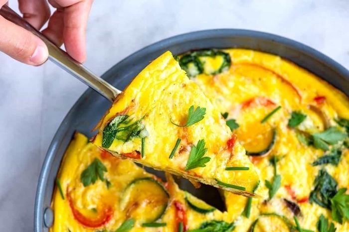 baked eggs, with peppers and zucchini, breakfast food ideas, metal spoon, grey plate