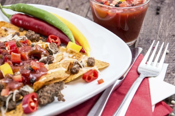 tomato juice, tortilla chips, covered in meat and salsa, nachos in white plate, best breakfast recipes