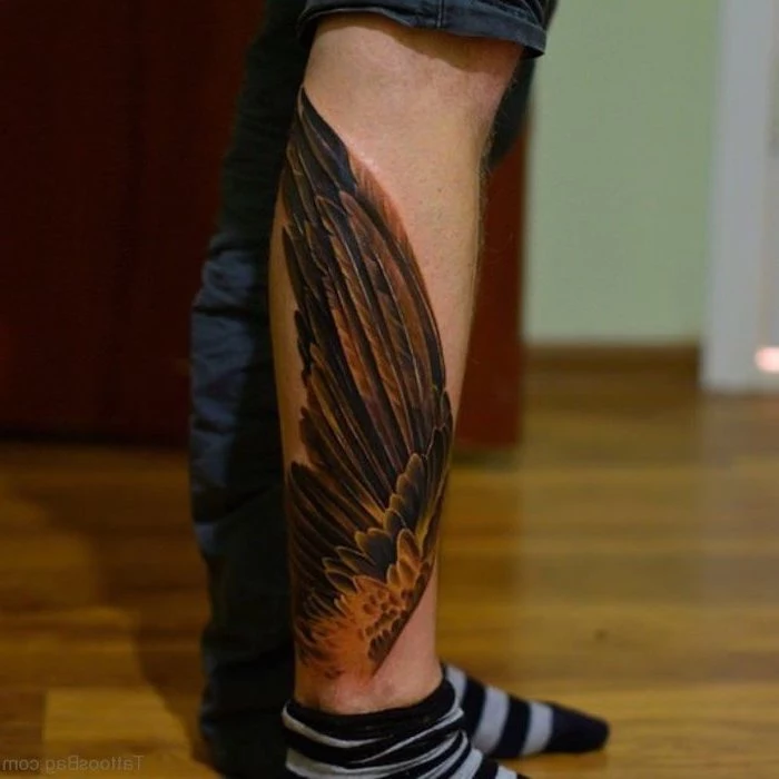 leg tattoo, brown wings, small angel wings tattoo, wooden floor, grey and black striped socks