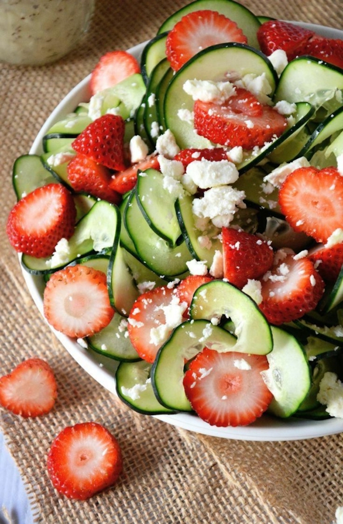 zucchini salad, with slices of strawberry, in a white bowl, garnished with cheese, brunch food ideas