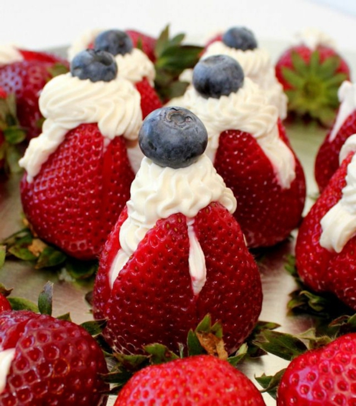 sliced strawberries, with cream, blueberries on top, brunch food ideas, wooden table