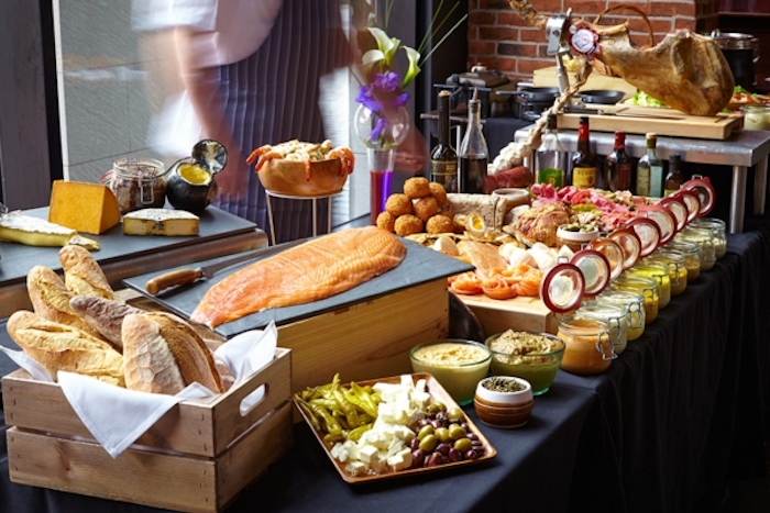 salmon fillet, cheese board, bread in a wooden crate, what is brunch, jars with different sauces