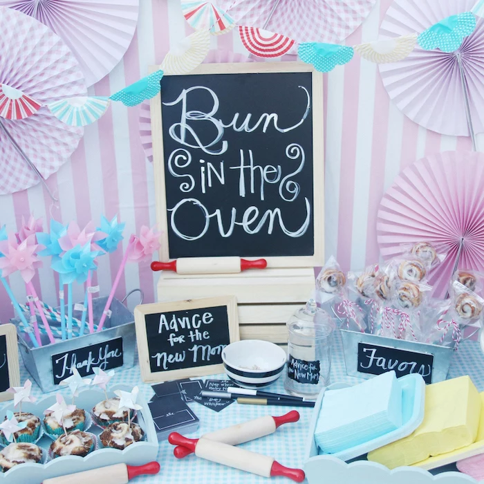 bun in the oven, black chalkboard, cinnamon buns, in a blue tray, colorful decorations, baby shower ideas