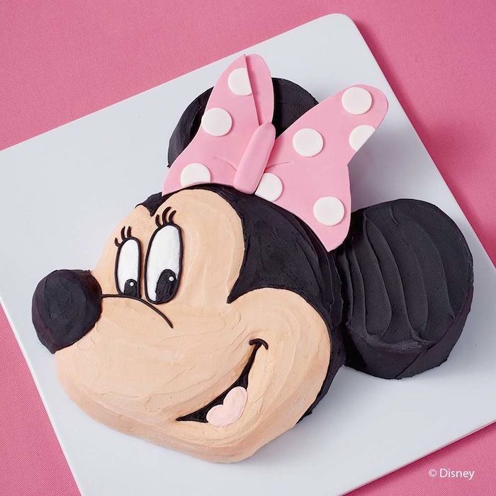 white tray, minnie mouse cake, in the shape of minnie's head, black and beige frosting