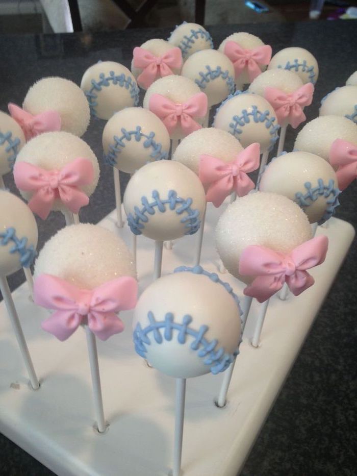 gender reveal box, cake pops, baseballs and pink bows, white tray