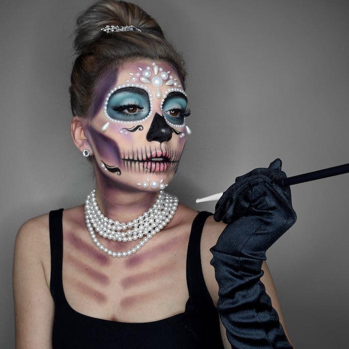 woman with calavera makeup, halloween costume ideas, wearing white pearls, black satin gloves, black dress