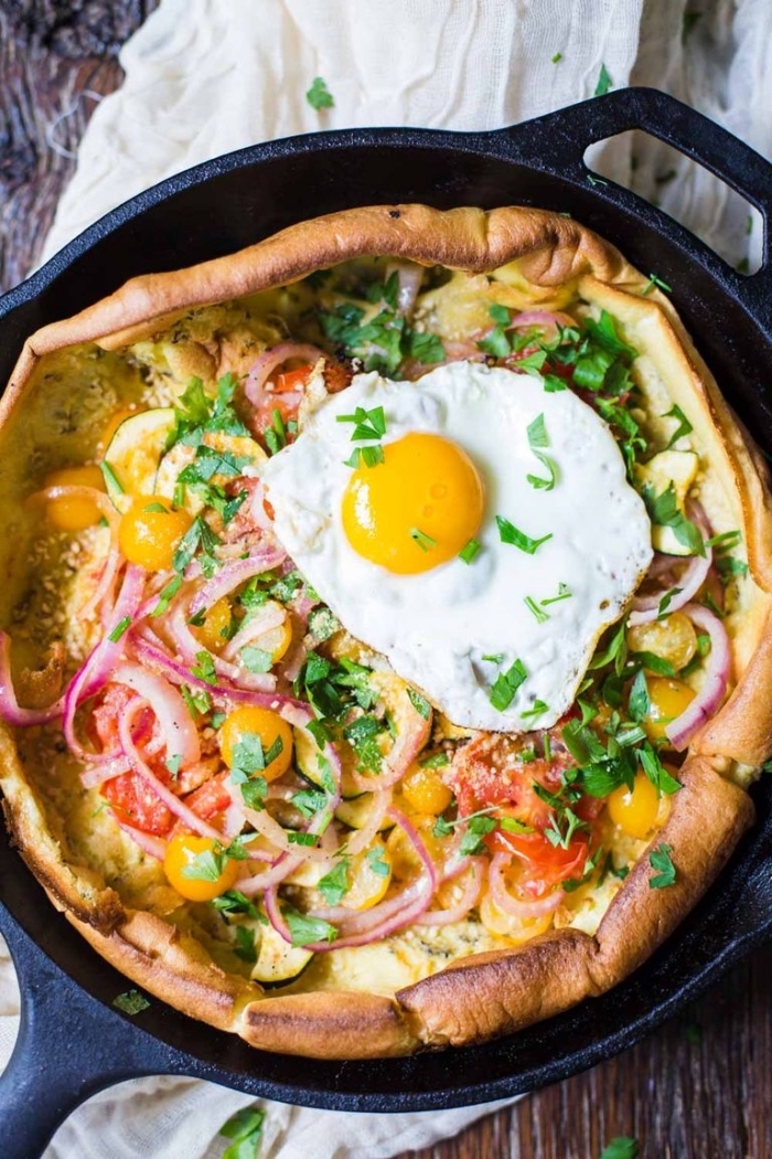 baked casserole, with cherry tomatoes, onion and peppers, egg on top, breakfast dishes