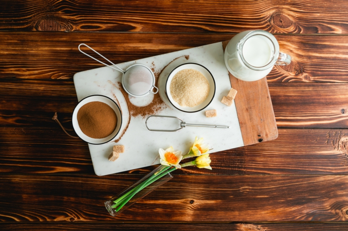 sugar and instant coffee, milk in a pitcher, cloud coffee recipe, arranged on wooden surface