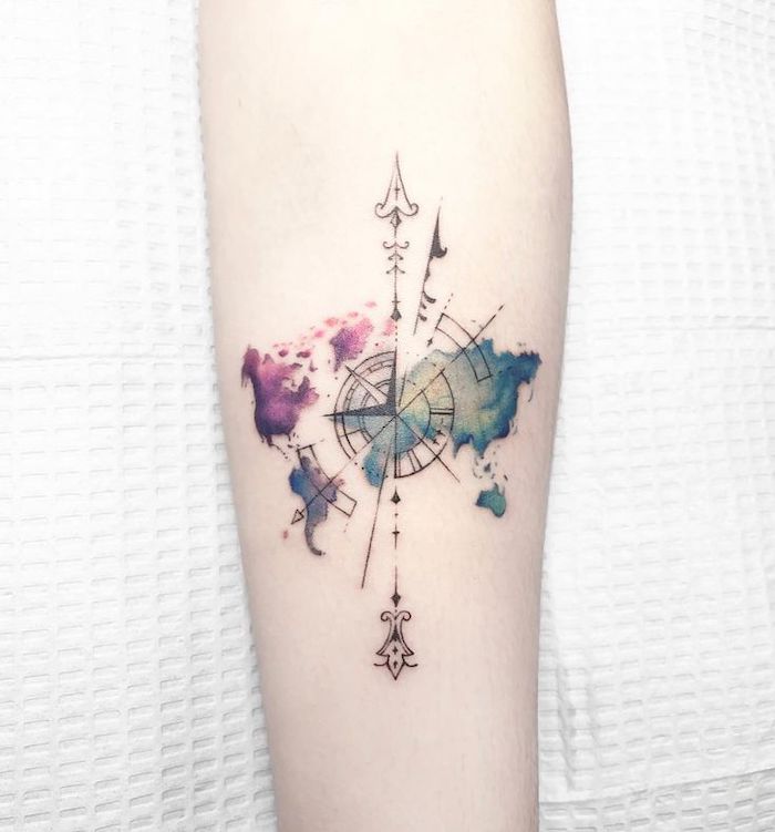 watercolor tattoo, map of the world, small compass tattoo, white sheet of paper, forearm tattoo
