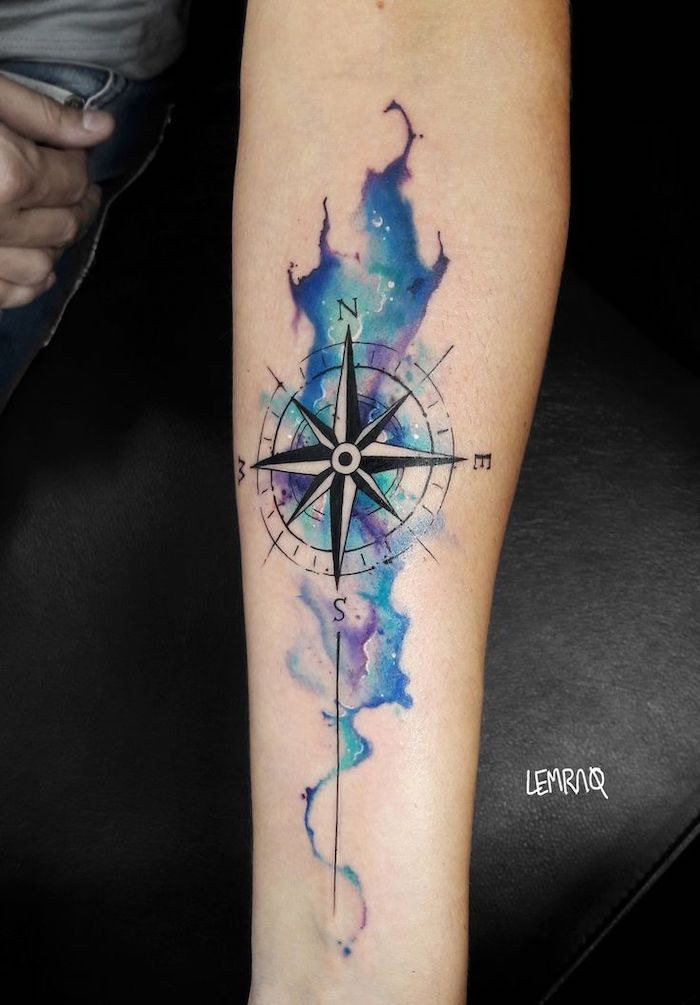 compass rose tattoo, watercolor tattoo, blue and purple colors, forearm tattoo, black leather bed