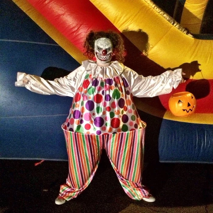 man dressed as clown, scary clown mask, cute halloween costumes, bouncy castle