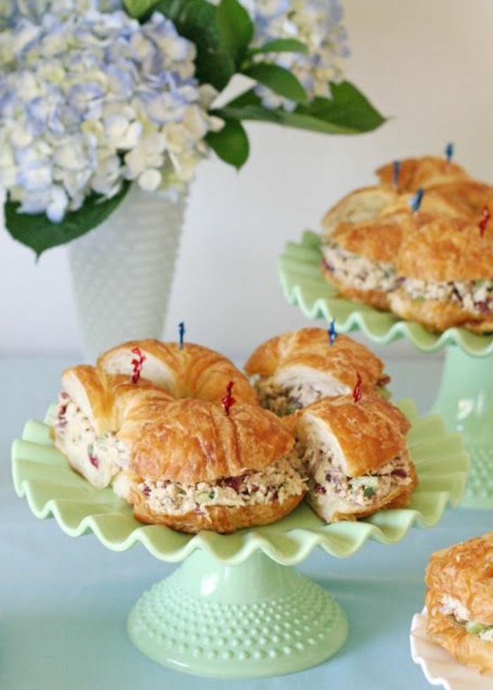 halved croissants, with filling, on green cake stands, brunch menu ideas, flower bouquet