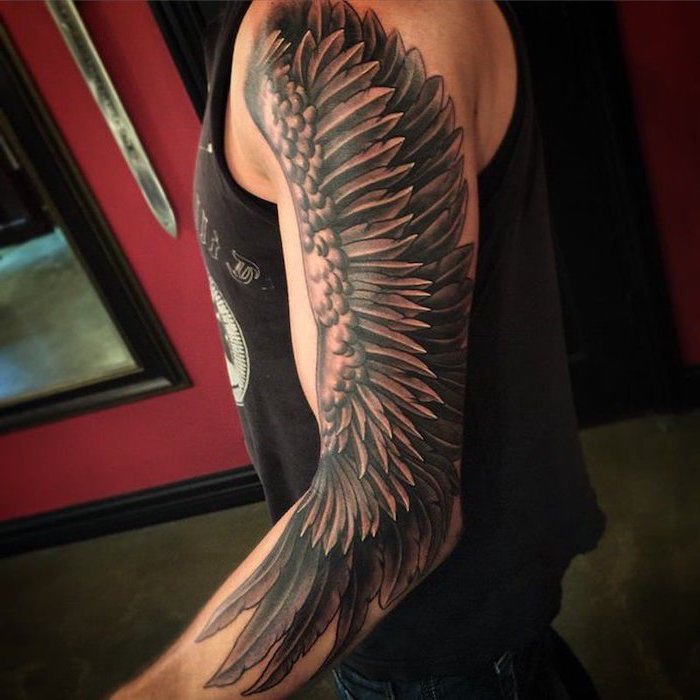 arm sleeve tattoo, fallen angel tattoo, angel wing, man with black top, red background, watercolor angel tattoo