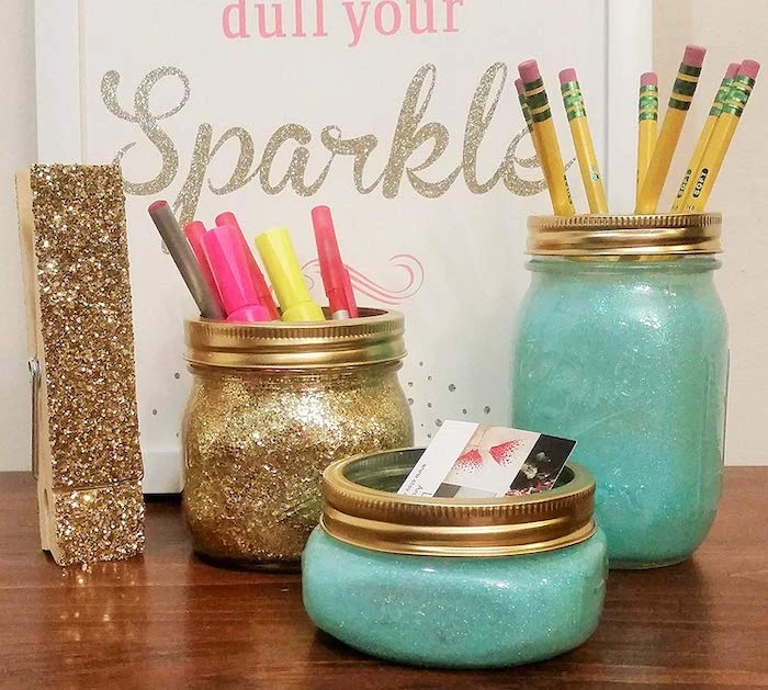 mason jars, covered in blue and gold glitter, gold glitter peg, cubicle wallpaper, wooden desk