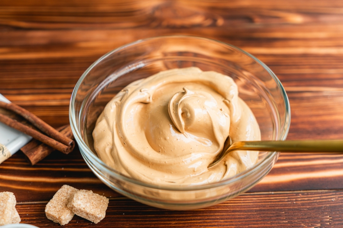 whipped coffee, dalgona coffee recipe, placed in glass bowl, placed on wooden surface