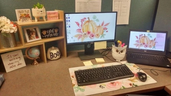 desktop computer and laptop, cubicle wallpaper, floral keyboard pad, wooden desk organiser, flower bouquet
