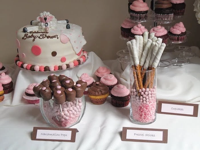 girl baby shower, cake with white fondant, sweet pretzels, cupcakes and marshmallow pops