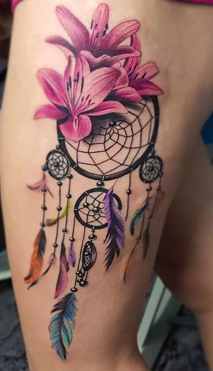 three pink orchids, on top of dreamcatcher, dream catcher tattoo on thigh, colorful feather