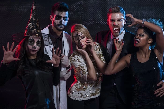 group of people, dressed with different costumes, halloween costumes, posing for a photo