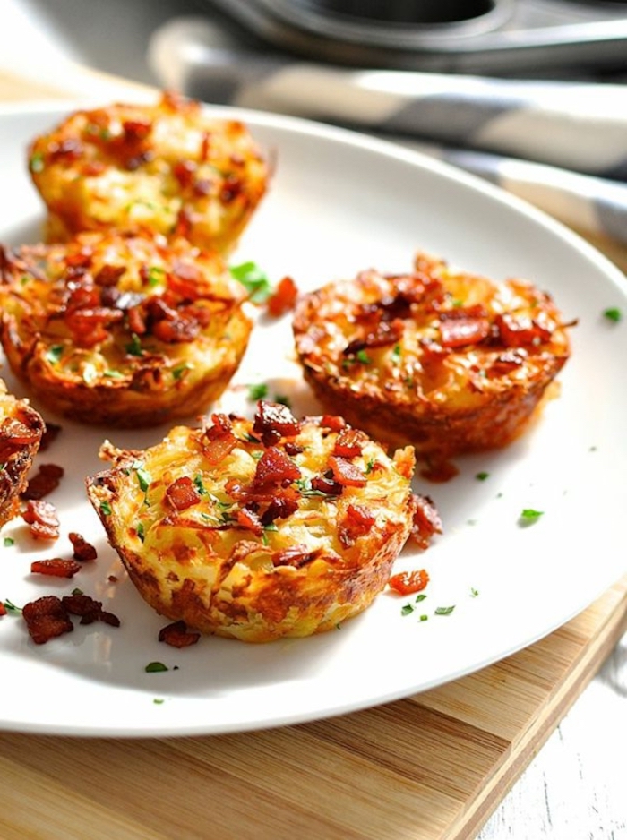 great breakfast ideas, eggs with bacon, chives and cheese, in white plate, wooden table