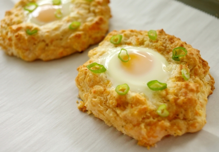 fried eggs, chives on top, on wooden table, breakfast brunch