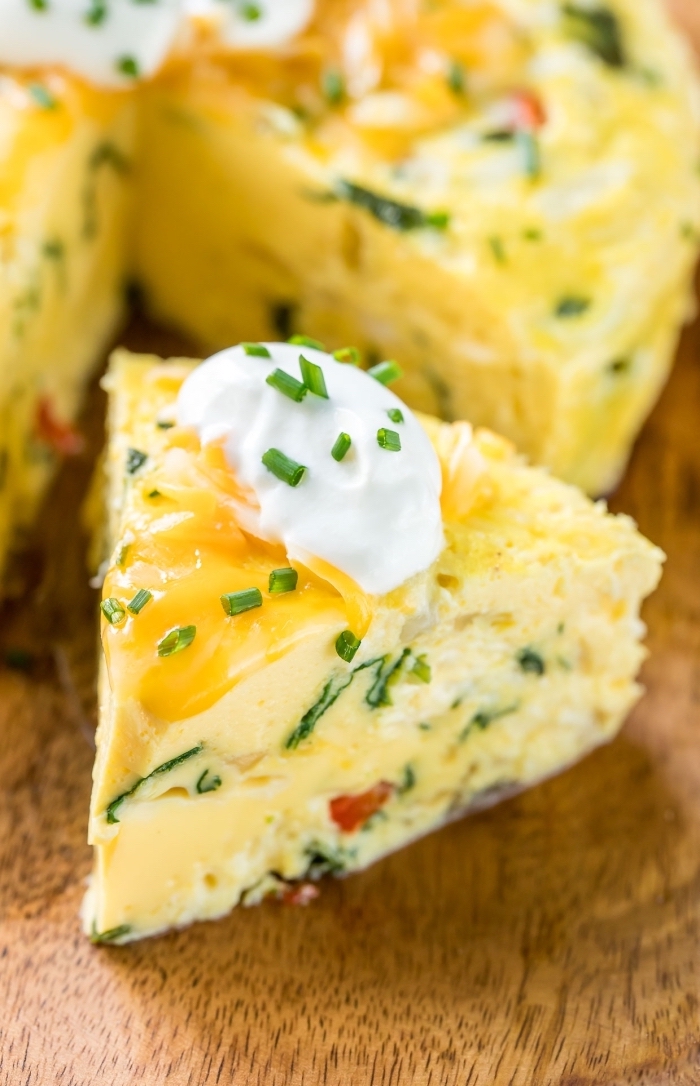 baked eggs, sour cream and chives on top, breakfast brunch, wooden table