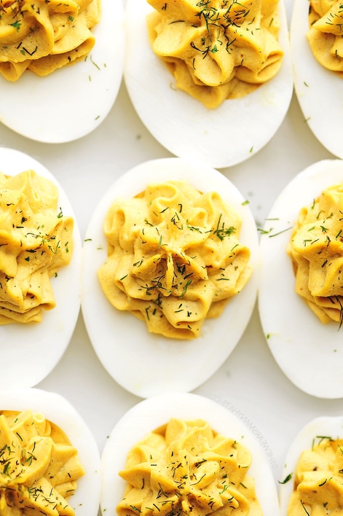 eggs with mayo inside, dill on top, breakfast brunch, white table