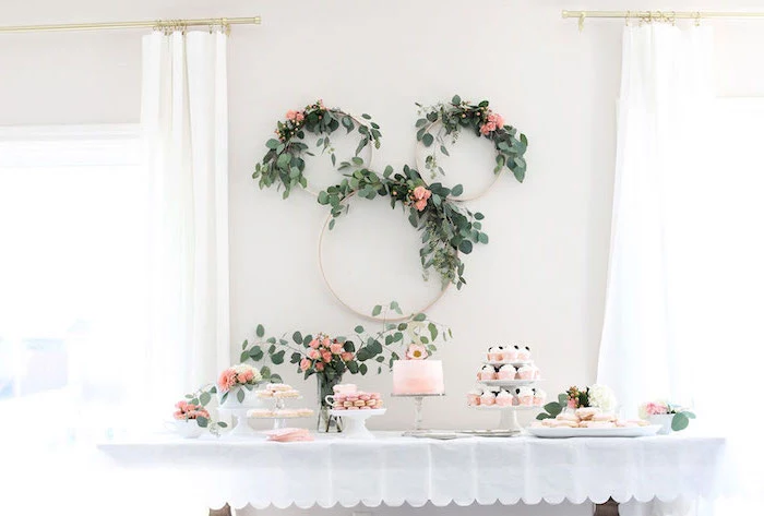 floral wreaths, on white wall, dessert table, dinosaur baby shower, cake and cupcakes, flower bouquets