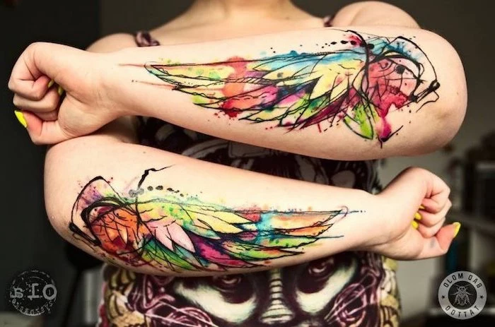 watercolor tattoo, angel and devil tattoo, forearm tattoos, on both hands, yellow nail polish