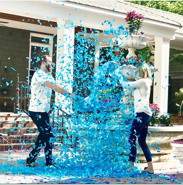 man and woman, fighting with pillows, gender reveal ideas, blue confetti in the air
