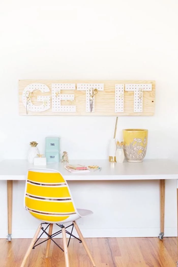 get it, peg board, wooden floor, white desk, yellow chair, office cubicle decor, tin cans, white wall