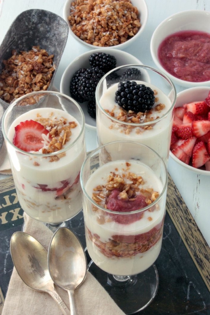 granola and yoghurt, in a glass, breakfast menu ideas, different garnish, in white bowls