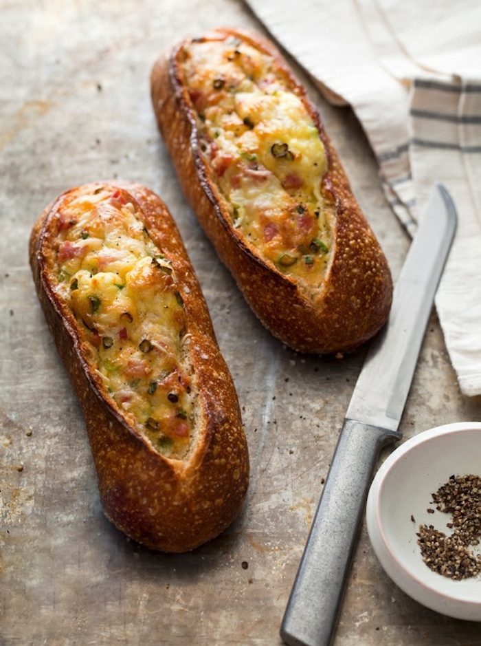 bread with filling, eggs and bacon inside, breakfast menu ideas, silver knife, granite countertop