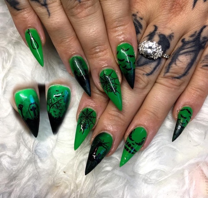 green nail polish, cute acrylic nail designs, black cemetery decorations, spider webs, trees and bats, long stiletto nails