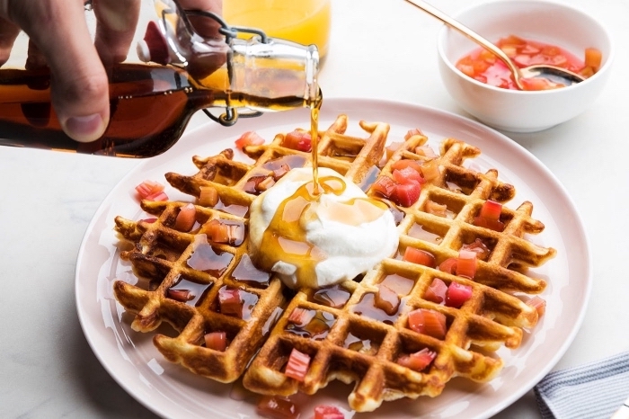 large waffle, with jam, cream and honey, breakfast potluck, white plate, small white bowl with jam