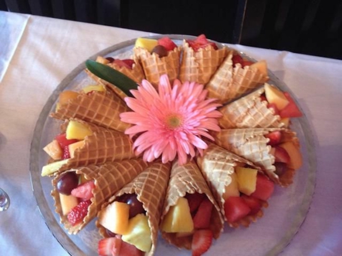 ice cream cones, filled with fruit, brunch items, strawberries and grape, pineapple and melon