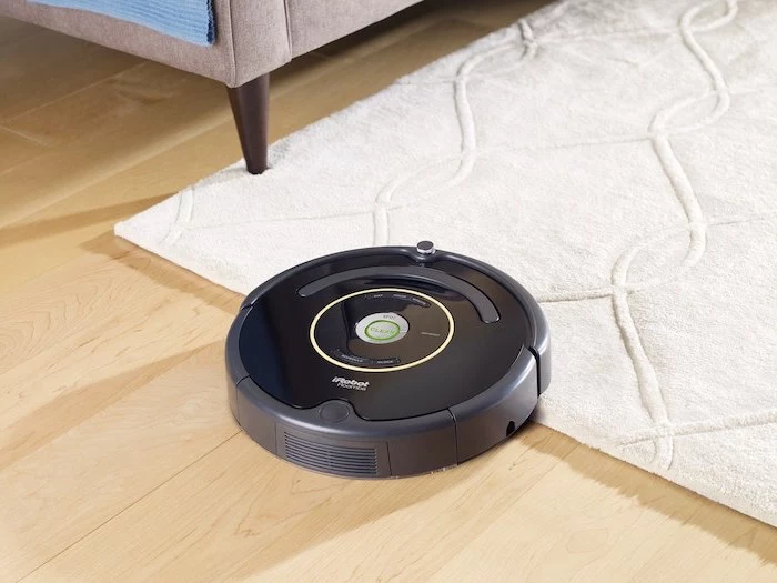 roomba irobot, best vacuum cleaner, wooden floor, white carpet, gray sofa