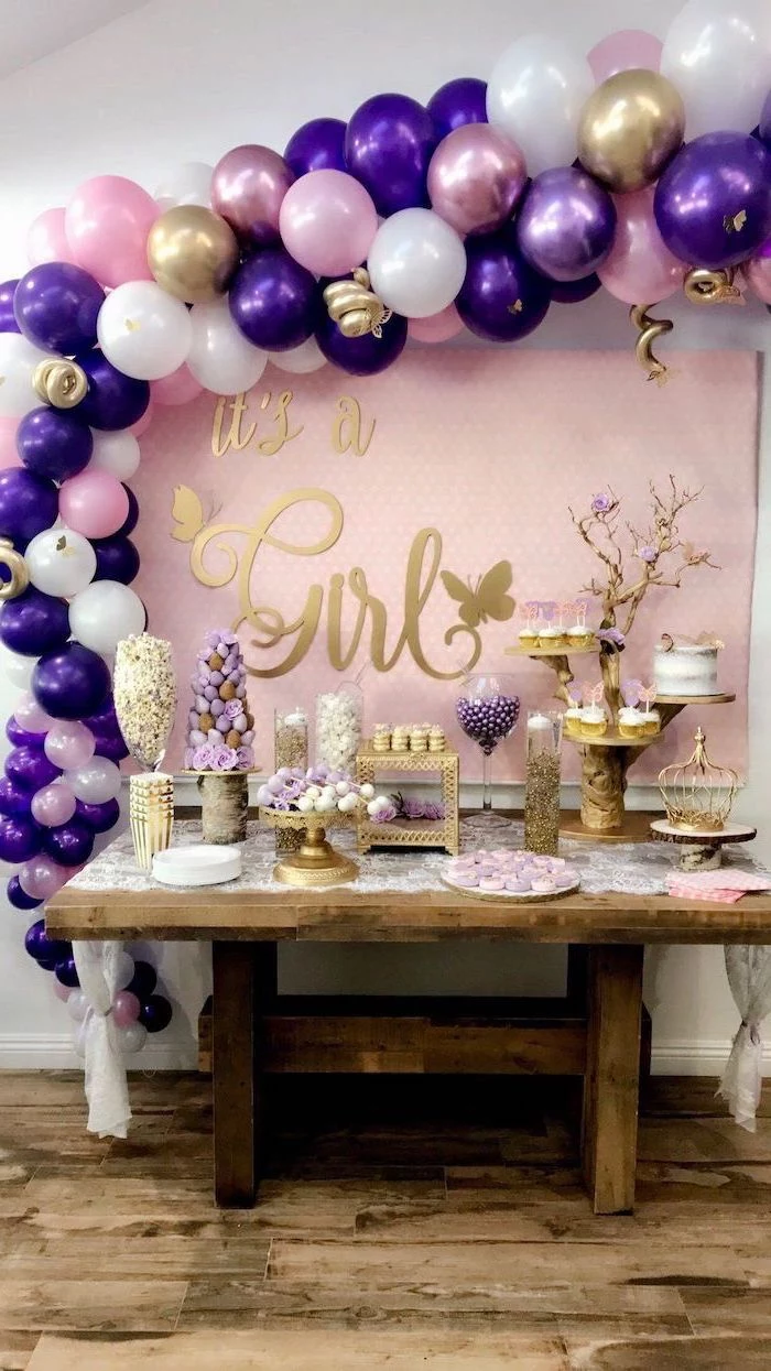 it's a girl, wooden table, dessert table, rustic decor, purple pink and white balloons, baby shower centerpieces girl
