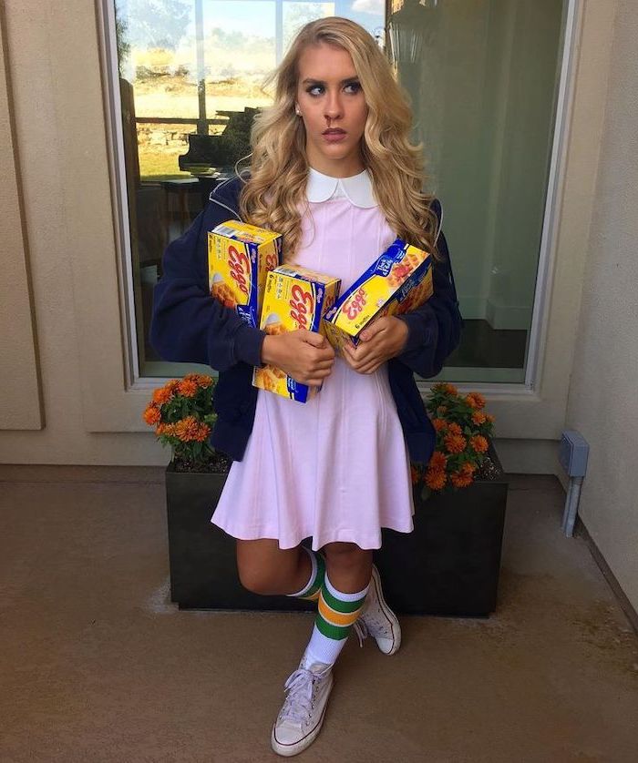 what should i be for halloween, woman dressed as eleven, from stranger things, holding boxes of eggo waffles